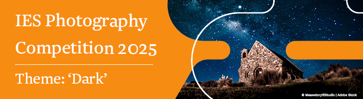 A banner image with an orange background, with a shape overlaid with a photograph of a dark night sky with stars and a stone building. The text reads: IES Photography Competition 2025 - Theme: Dark