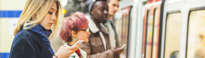 People checking social media near a train